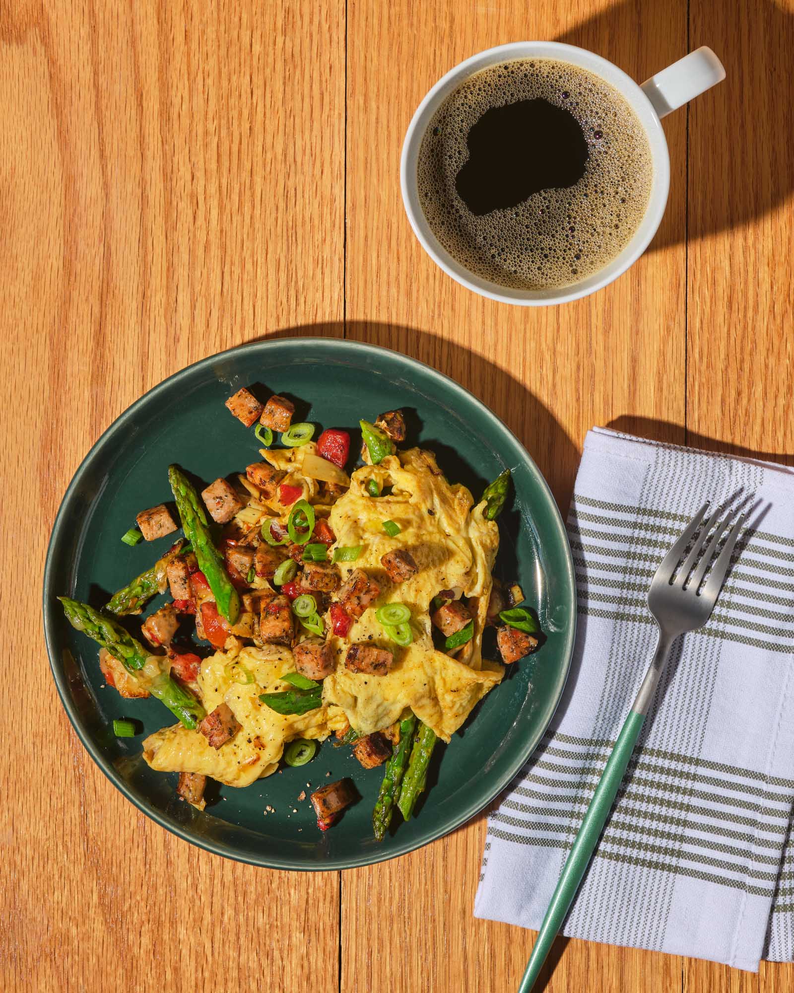 Hearty scrambled eggs with Italian Herb chicken sausage, asparagus, artichokes, roasted red peppers, and melted fontina cheese.