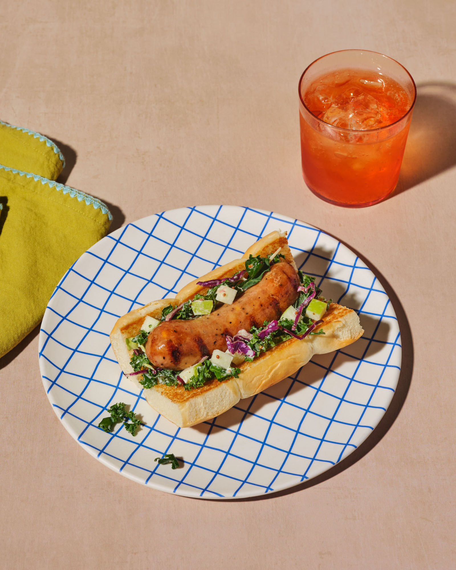 Grilled Melty Cheddar chicken sausages nestled in Hawaiian buns, topped with tangy apple and broccoli slaw.