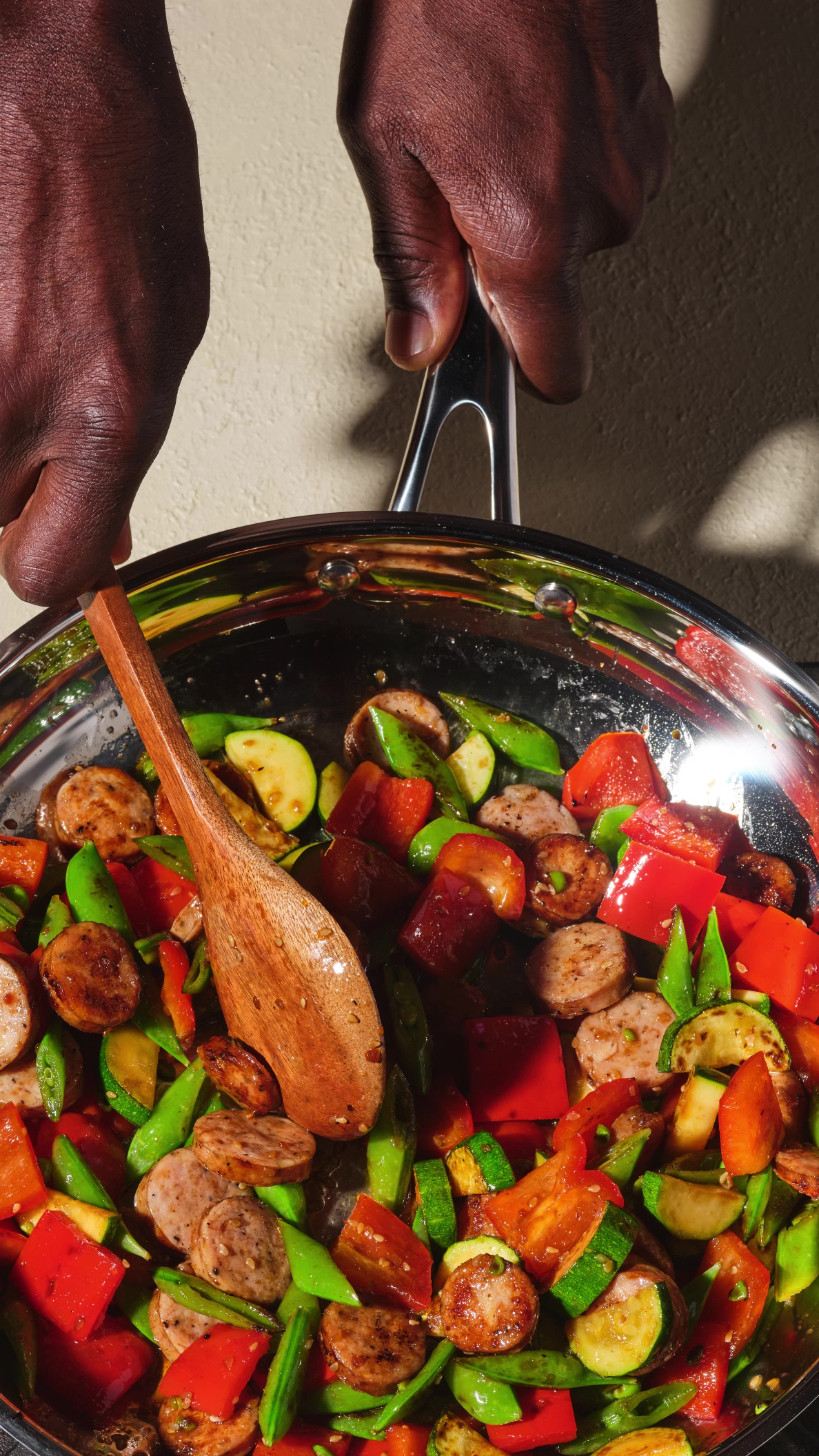 Colorful chicken sausage teriyaki stir-fry with bell peppers, zucchini, and snow peas served over steamed rice.