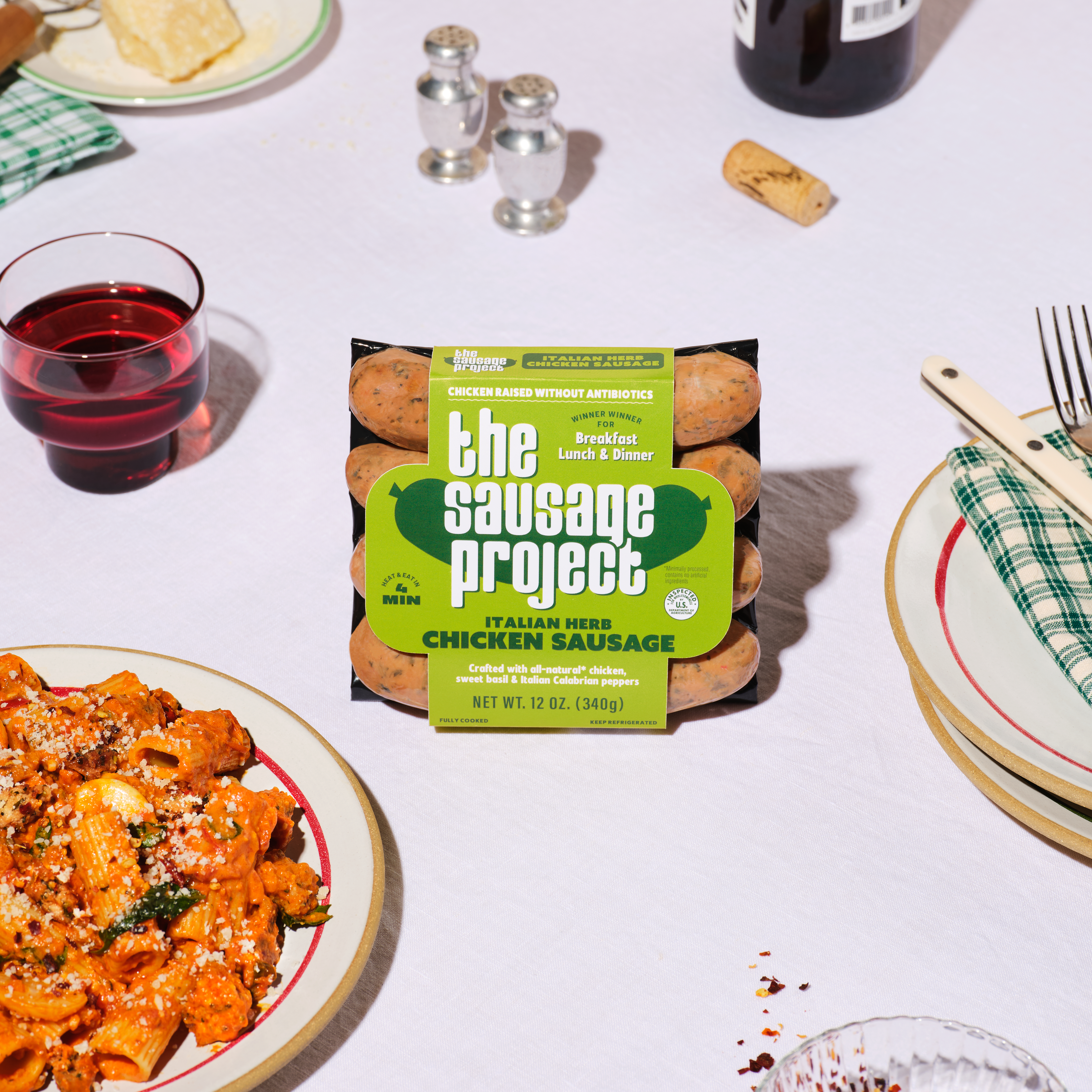 The Sausage Project's alongside a bowl of creamy pink pasta.
