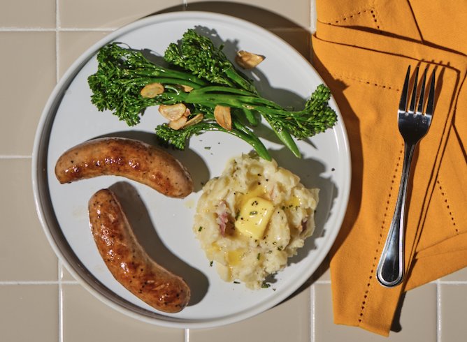 A delicious plate of buttery mashed potatoes, broccolini, and The Sausage Project Classic Roasted Chicken Sausage.