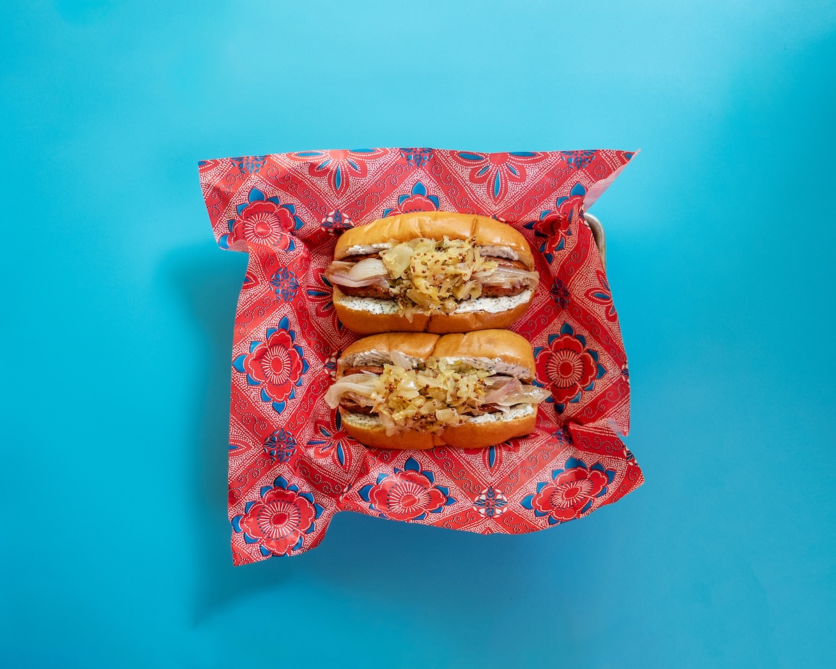 A Seattle-style Classic Roasted Chicken Sausage featuring everything bagel cream cheese, caramelized onions, and IPA-steeped sauerkraut.
