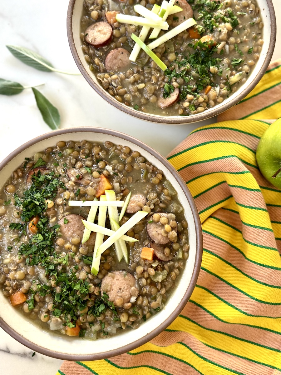 A hearty bowl of lentil soup loaded with apples and The Sausage Project.