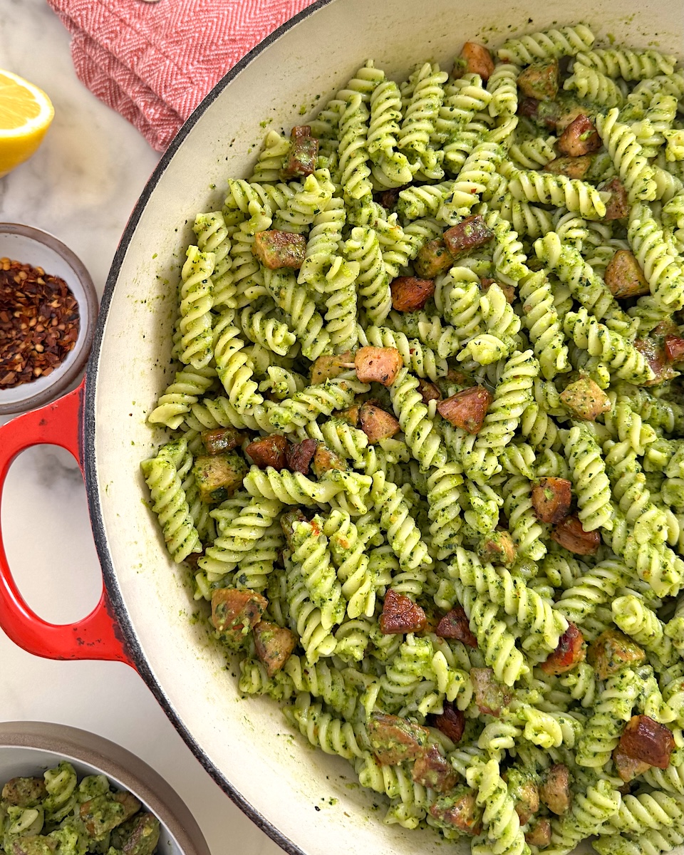 A bowl of verdant fusilli with pesto and chicken sausage.