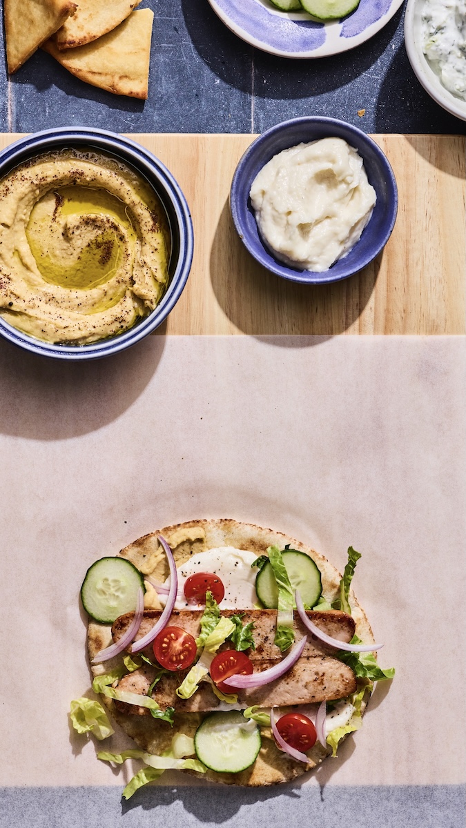 A sausage-stuffed pita ready to be wrapped.