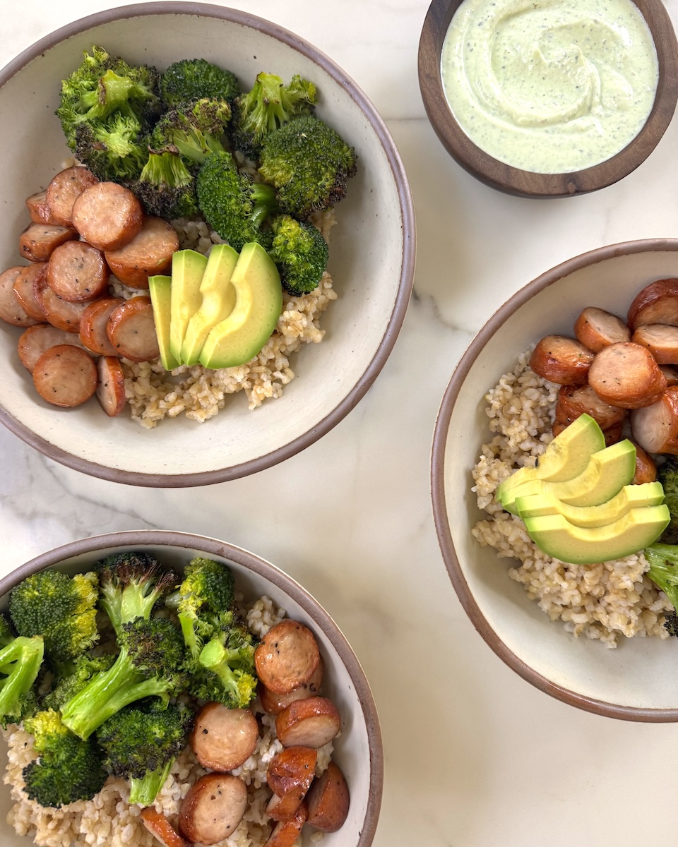 Three hearty bowls of brown rice, Classic Roasted Chicken Sausage with a side of creamy Greek yogurt green goddess dressing.