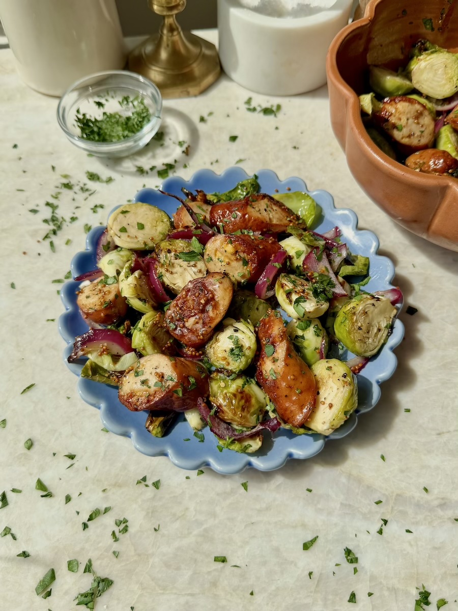 A bowl of air-fried chicken sausage and brussels sprouts.