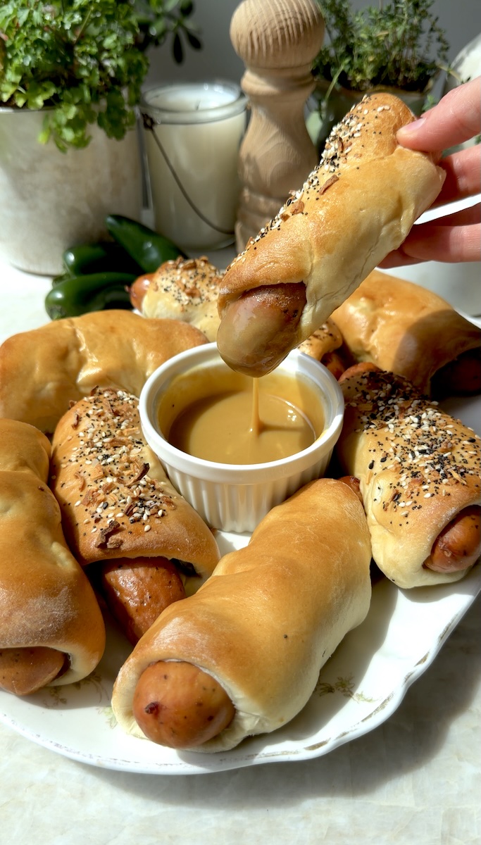A plate of tasty chicken sausage jalapeño kolaches with mustard dip.