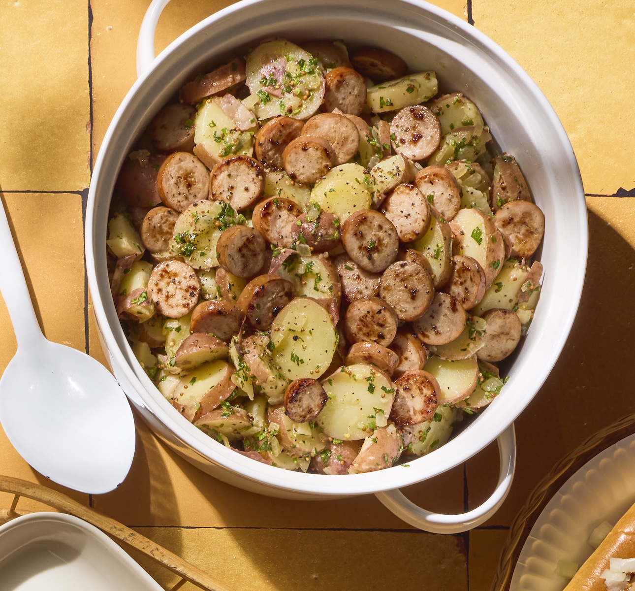 A large bowl of German potato salad loaded with Classic Roasted Chicken Salad.