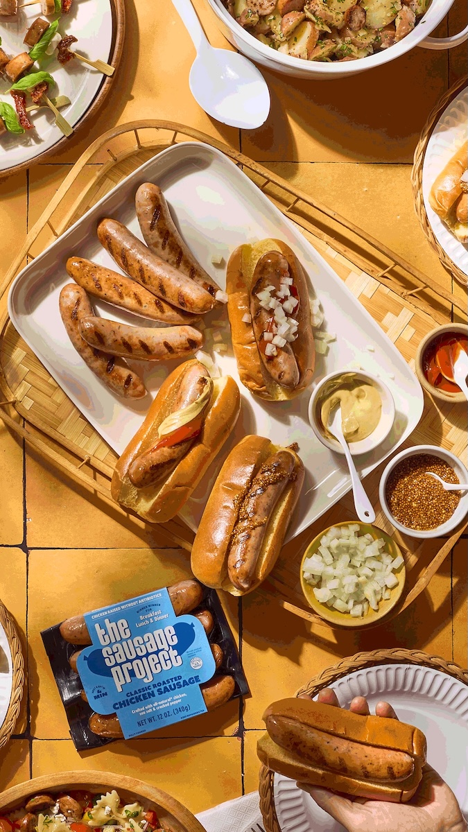 A pile of grilled sausages and sides