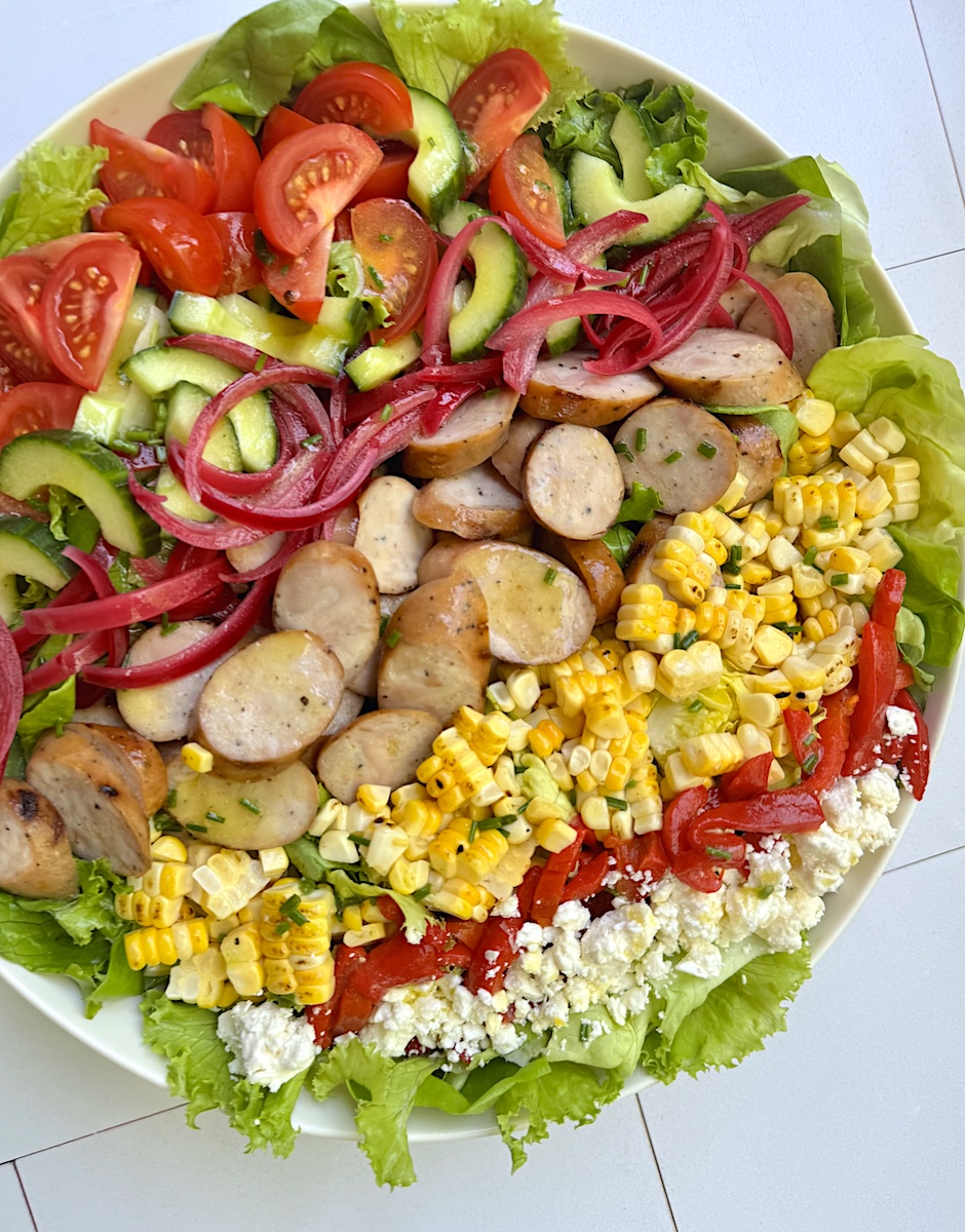 A tasty chopped salad with chicken sausage and summer vegetables.