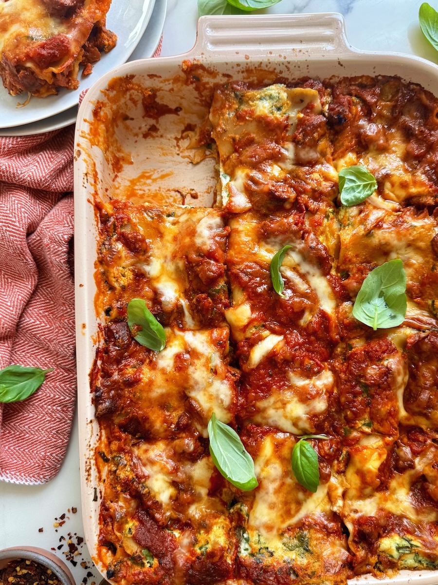 A dish of lasagna with one square removed.