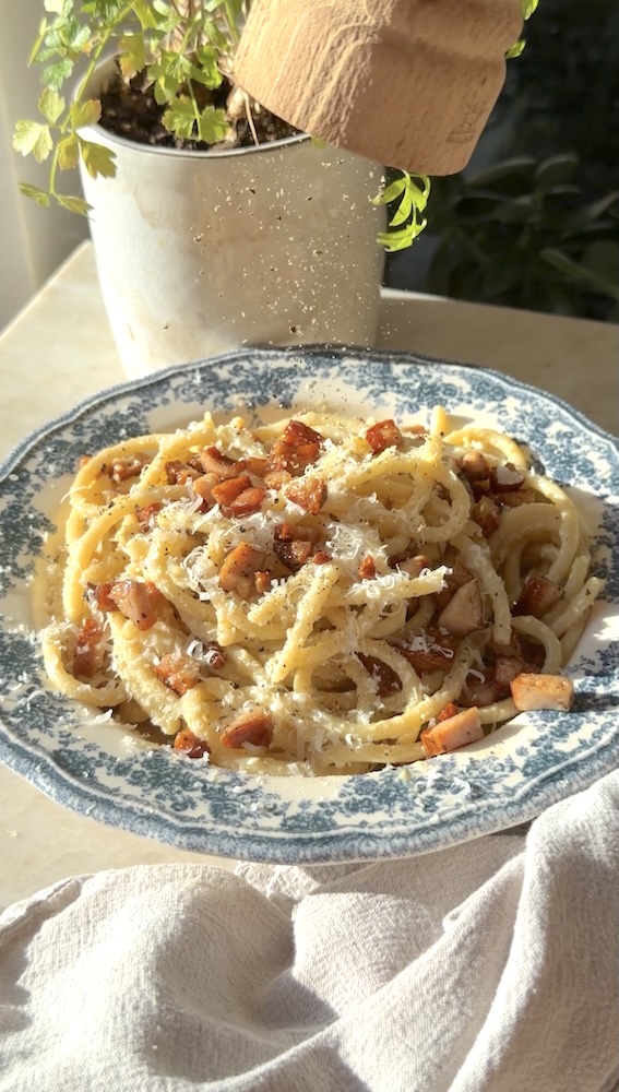 A steaming bowl of chicken sausage carbonara.
